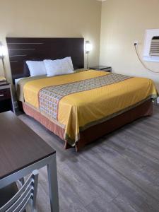 ein Hotelzimmer mit einem Bett und einem Tisch in der Unterkunft Savannah Motel in Savannah