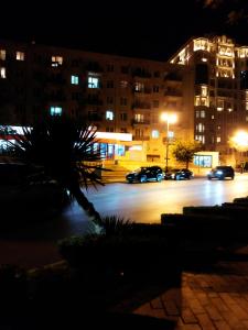 a parking lot at night with cars parked at Budget One Room Apartment in Baku