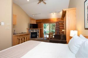 a bedroom with a bed and a living room at Tigh-Na-Mara Seaside Spa Resort in Parksville