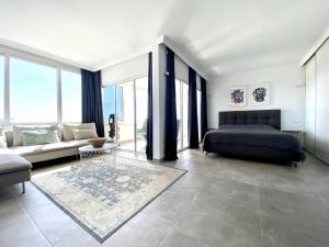 a bedroom with a bed and a couch at Excelsior I Sea View Apartment in Maspalomas