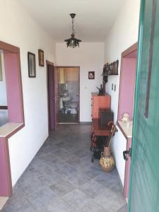 a hallway of a house with a table and a chair at Apartments by the sea Drvenik Veliki, Drvenik - 19229 in Drvenik Veli