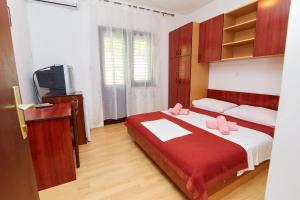 a bedroom with a bed with two pink pillows on it at Apartments and rooms with parking space Crikvenica - 19125 in Crikvenica