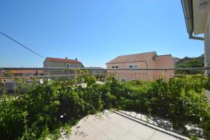 a row of plants on a balcony of a house at Apartments by the sea Tkon, Pasman - 19024 in Tkon +11 photos
