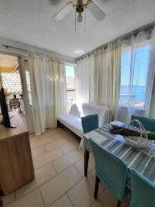 a living room with a couch and a table with chairs at Apartments by the sea Pakostane, Biograd - 19005 in Pakoštane