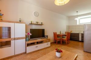 a living room with a television and a table at Holiday house with a parking space Vela Luka, Korcula - 19040 in Vela Luka