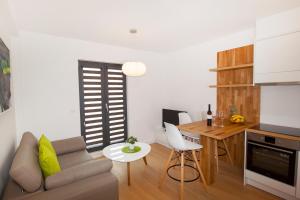 a small living room with a couch and a table at Apartments by the sea Makarska - 19145 in Makarska