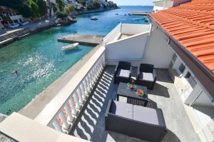 a balcony with chairs and a view of the water at Seaside house for families with children Zavalatica, Korcula - 19045 in Čara