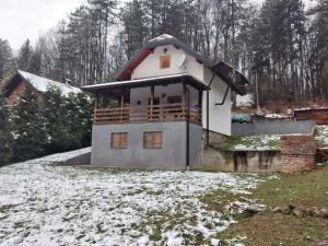 a house with snow on the ground in front of it at Family friendly house with a parking space Garesnica, Bjelovarska - 19166 in Garešnica +6 photos
