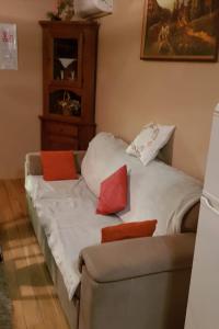 a bed with red and white pillows on it at Family friendly house with a parking space Garesnica, Bjelovarska - 19166 in Garešnica