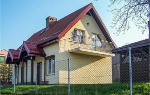 a yellow house with a brown roof at 2 Bedroom Pet Friendly Home In Mielno in Mielno