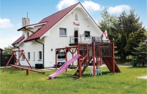 a group of playground equipment in front of a house at Gorgeous Home In Rusinowo With Wifi in Jarosławiec