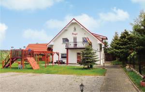 a house with a playground in front of it at Stunning Home In Rusinowo With 7 Bedrooms And Wifi in Jarosławiec