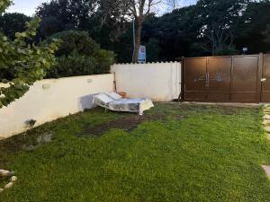 a mattress sitting in a yard next to a fence at Casaflavio in Torvaianica