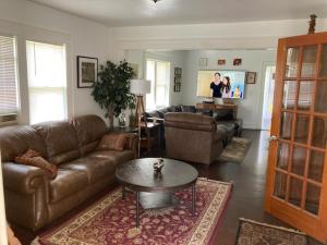 a living room with a couch and a coffee table at Country House on 1 Acre 4 Beds Great for Events or a quiet weekend! in Independence