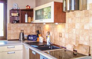 a kitchen with a sink and a counter top at Amazing Home In Izbica With 3 Bedrooms, Wifi And Outdoor Swimming Pool in Kluki