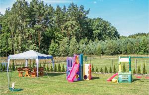 a group of playground equipment in a field at Amazing Home In Izbica With 3 Bedrooms, Wifi And Outdoor Swimming Pool in Kluki