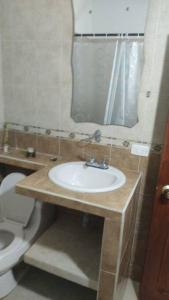 a bathroom with a sink and a toilet at Agradable apto independiente con tres cuartos y capacidad para 5 personas, equipada para una agradable estadia in Palmira +19 photos