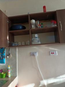 a kitchen with wooden cabinets and a counter top at Mkombodzi Global Homes in Mtwapa