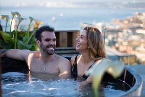 a man and a woman sitting in a pool of water at Verso Hotel in Valparaíso