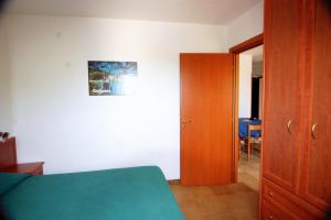 una camera da letto con un letto e una porta di legno di Village GEMINI a Peschici Altre 37 foto