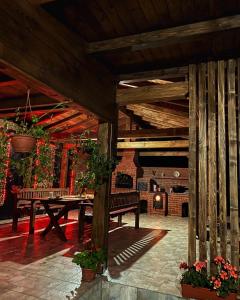 a patio with a wooden bench and a fireplace at Vila Sorina in Borşa