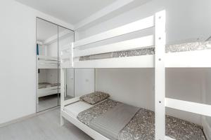 a bedroom with two bunk beds and a mirror at Sand Club Helen , 256, Golf del Sur Tenerife , España in San Miguel de Abona +25 photos