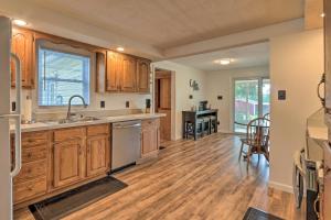 a kitchen with wooden cabinets and a dining room at Berryville Home Near Wineries Mountain Views in Berryville