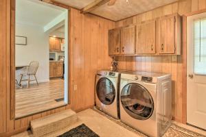 a washer and dryer in a kitchen with wooden cabinets at Berryville Home Near Wineries Mountain Views in Berryville
