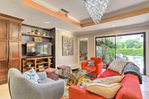 a living room with a red couch and chairs at Pool, Grill and Game Room Bermuda Dunes Oasis in Bermuda Dunes