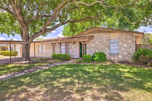 a stone house with a tree and a yard at San Antonio Home with Yard, 7 Mi to SeaWorld! in San Antonio