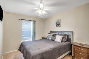 a bedroom with a bed and a ceiling fan at San Antonio Home with Yard, 7 Mi to SeaWorld! in San Antonio