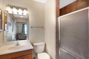 a bathroom with a toilet and a sink and a shower at San Antonio Home with Yard, 7 Mi to SeaWorld! in San Antonio
