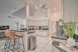 a kitchen with white cabinets and a ceiling fan at Crystal River Gem Near Three Sisters Springs! in Crystal River