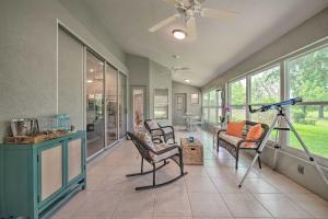 a living room with chairs and a camera on a tripod at Crystal River Gem Near Three Sisters Springs! in Crystal River