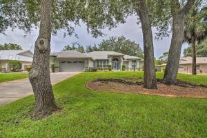 a house with trees in the front yard at Crystal River Gem Near Three Sisters Springs! in Crystal River