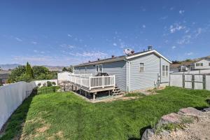 a white house with a fence and a yard at Lovely Lehi Retreat 27 Mi to Alta Ski Area! in Lehi
