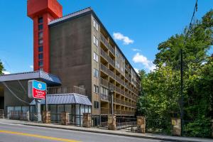 a building with a red tower on the side of a street at SureStay Plus Hotel by Best Western Gatlinburg in Gatlinburg