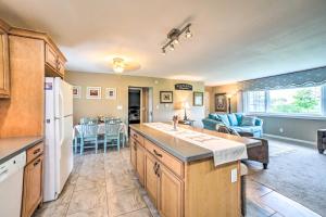 a kitchen and living room with a refrigerator and a table at Bloomington Family Home - Private Deck and Yard in Bloomington