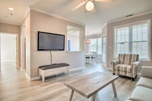 a living room with a flat screen tv on the wall at Rehoboth Beach Condo with Patio 5 Mi to Ocean! in Rehoboth Beach