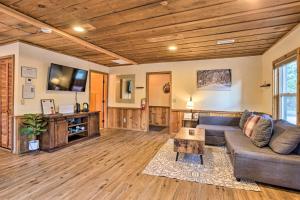 a living room with a couch and a tv at Peaceful Big Bear Cabin Walk to Lake Access! in Big Bear Lake