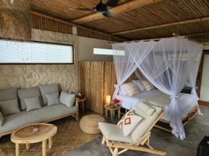 a bedroom with a bed with a mosquito net at Jellyfish Villas Bingin Beach in Uluwatu