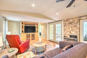 Una sala de estar con un sofá y un televisor. en Cheery Swansea Home on Calmont Pond with Dock!, en Swansea