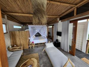 a bedroom with a bed and a net at Jellyfish Villas Bingin Beach in Uluwatu