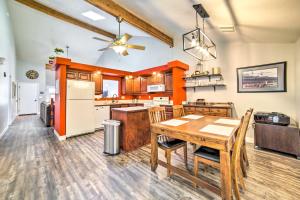 a large kitchen with a wooden table and chairs at Idaho Falls Townhome about 5 Mi to Tauthaus Park! in Idaho Falls