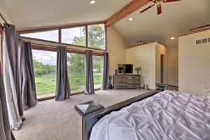 a large bedroom with a bed and a large window at Peaceful Lebanon FarmhouseandRanch with Pool! in Lebanon