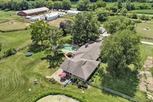 an aerial view of a farm with a house and a pool at Peaceful Lebanon FarmhouseandRanch with Pool! in Lebanon