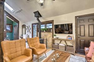 sala de estar con 2 sillas y chimenea en Woodsy Flagstaff Hideaway with Deck and Sunroom!, en Mountainaire