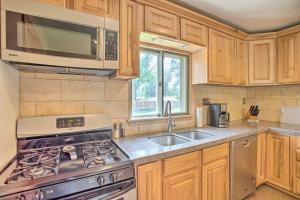 a kitchen with a stove and a microwave at Well-Appointed Fruita Townhome Hike and Bike Nearby in Fruita +16 photos