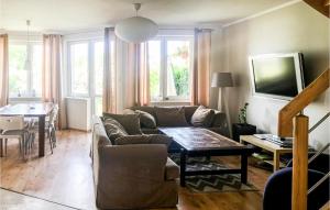 a living room with a couch and a table at Stunning Home In Darlowo With Wifi in Darłowo