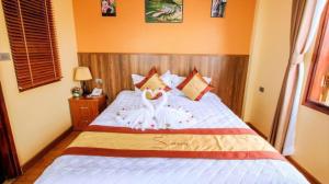 Postel nebo postele na pokoji v ubytování Heart Of Sapa Hotel